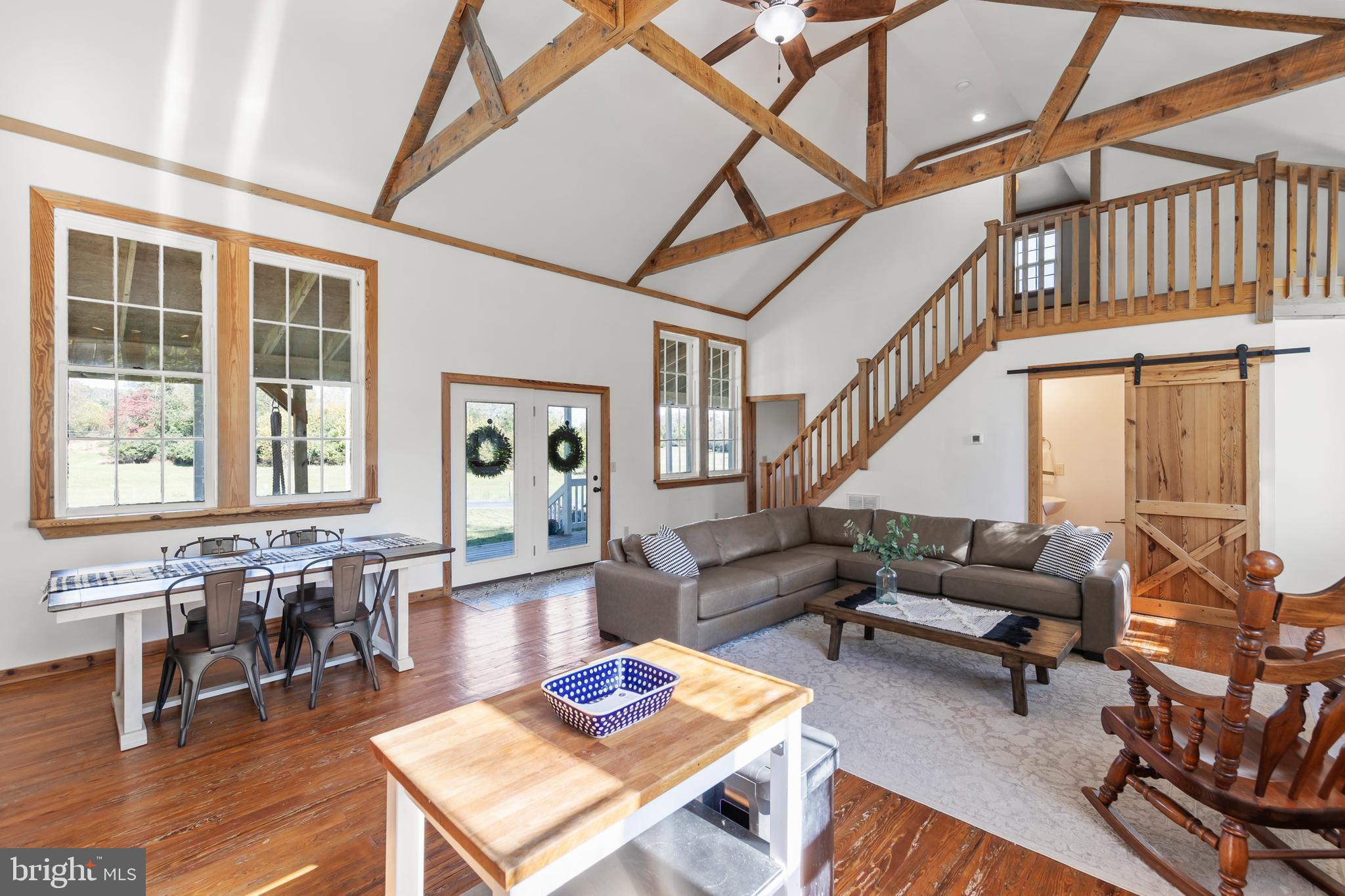 571 Rest Church Road Winchester, VA 22603 - Photo 44 of 45 a living room with furniture a table and wooden floor