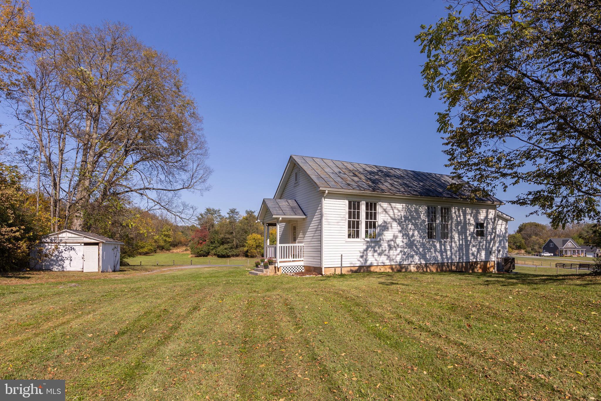 571 Rest Church Road Winchester, VA 22603 - Photo 35 of 45 a view of large house with a big yard and large trees