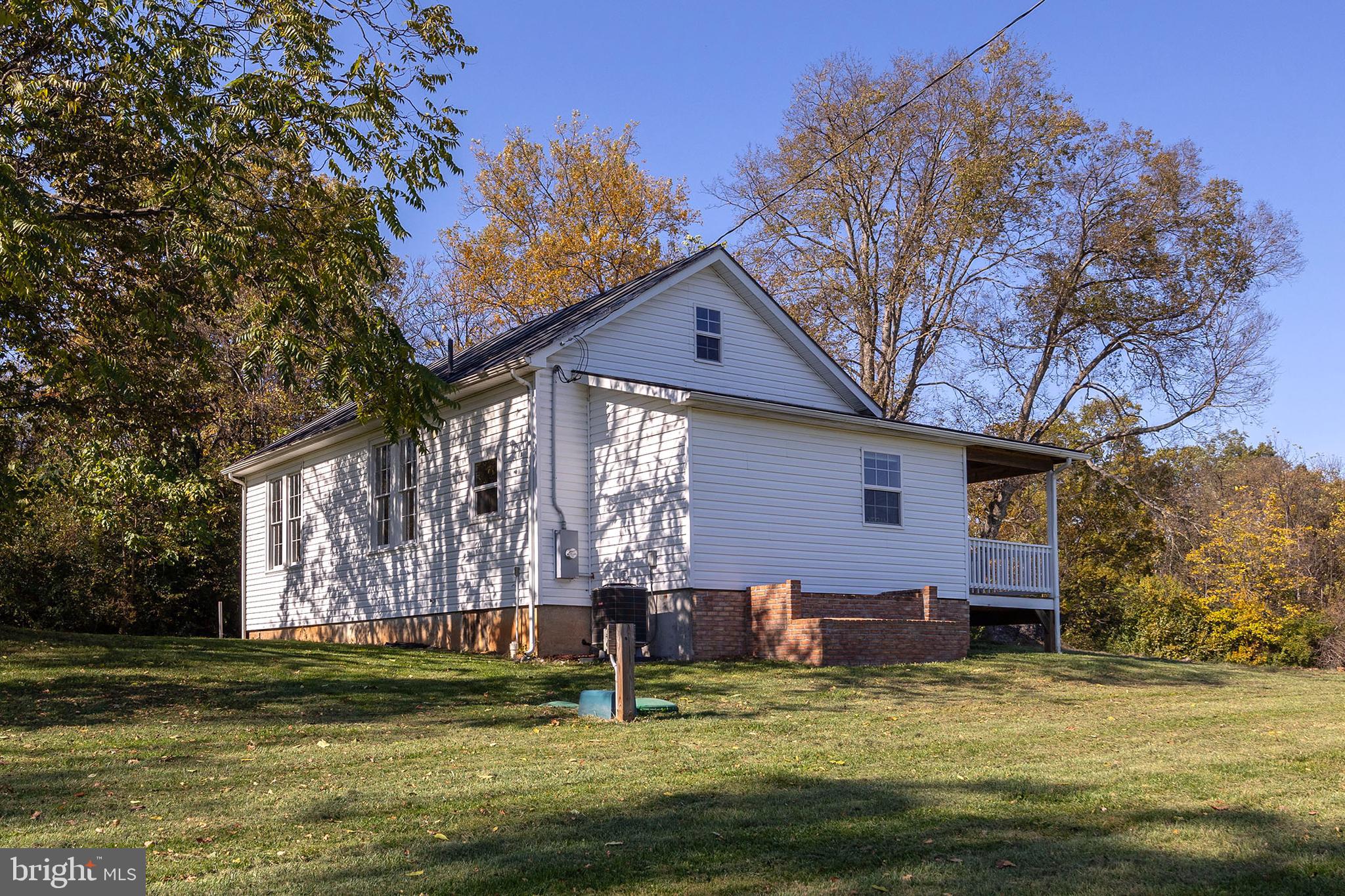 571 Rest Church Road Winchester, VA 22603 - Photo 38 of 45 a backyard of a house with swimming pool table and chairs