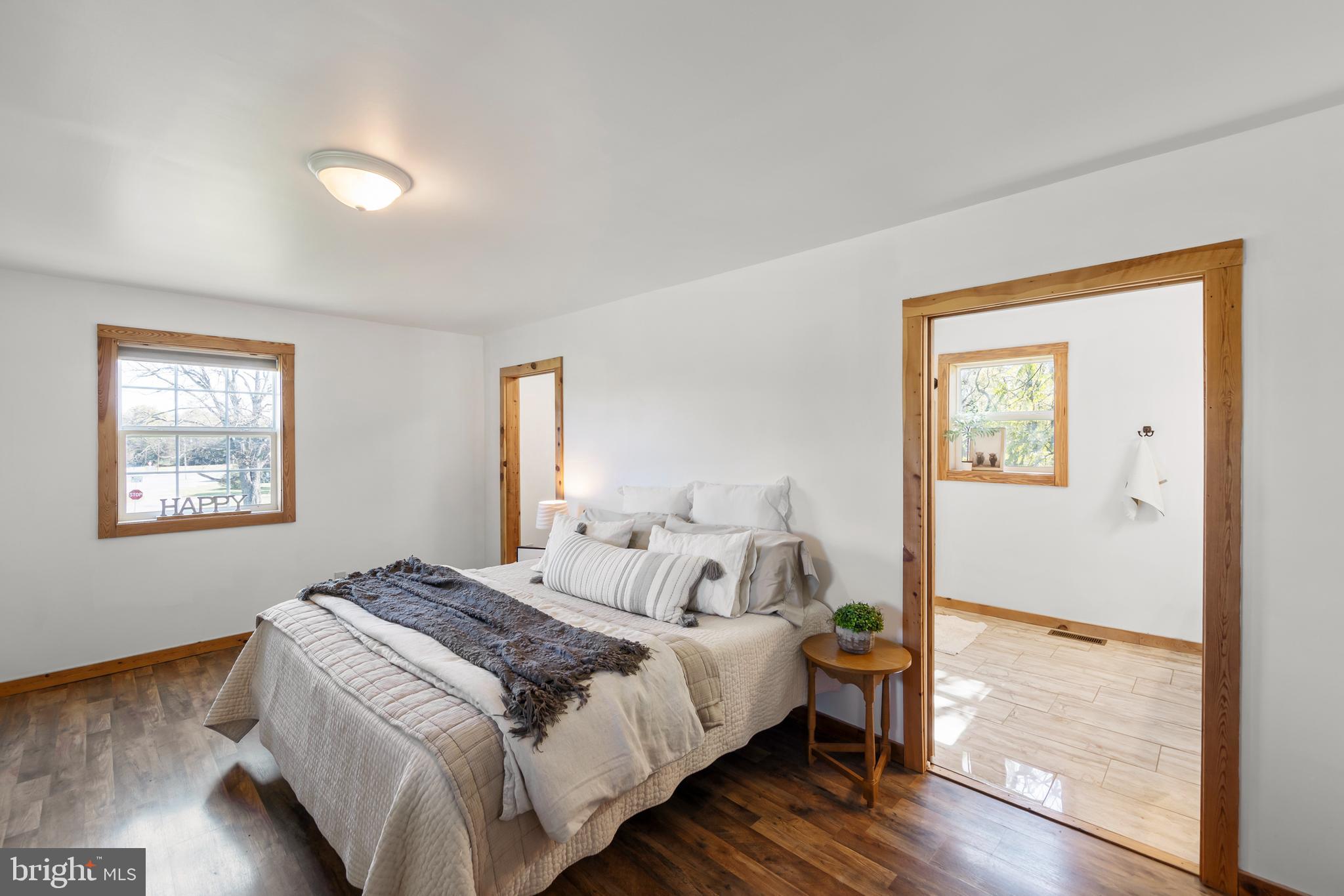 571 Rest Church Road Winchester, VA 22603 - Photo 4 of 45 a bedroom with a bed and wooden floor