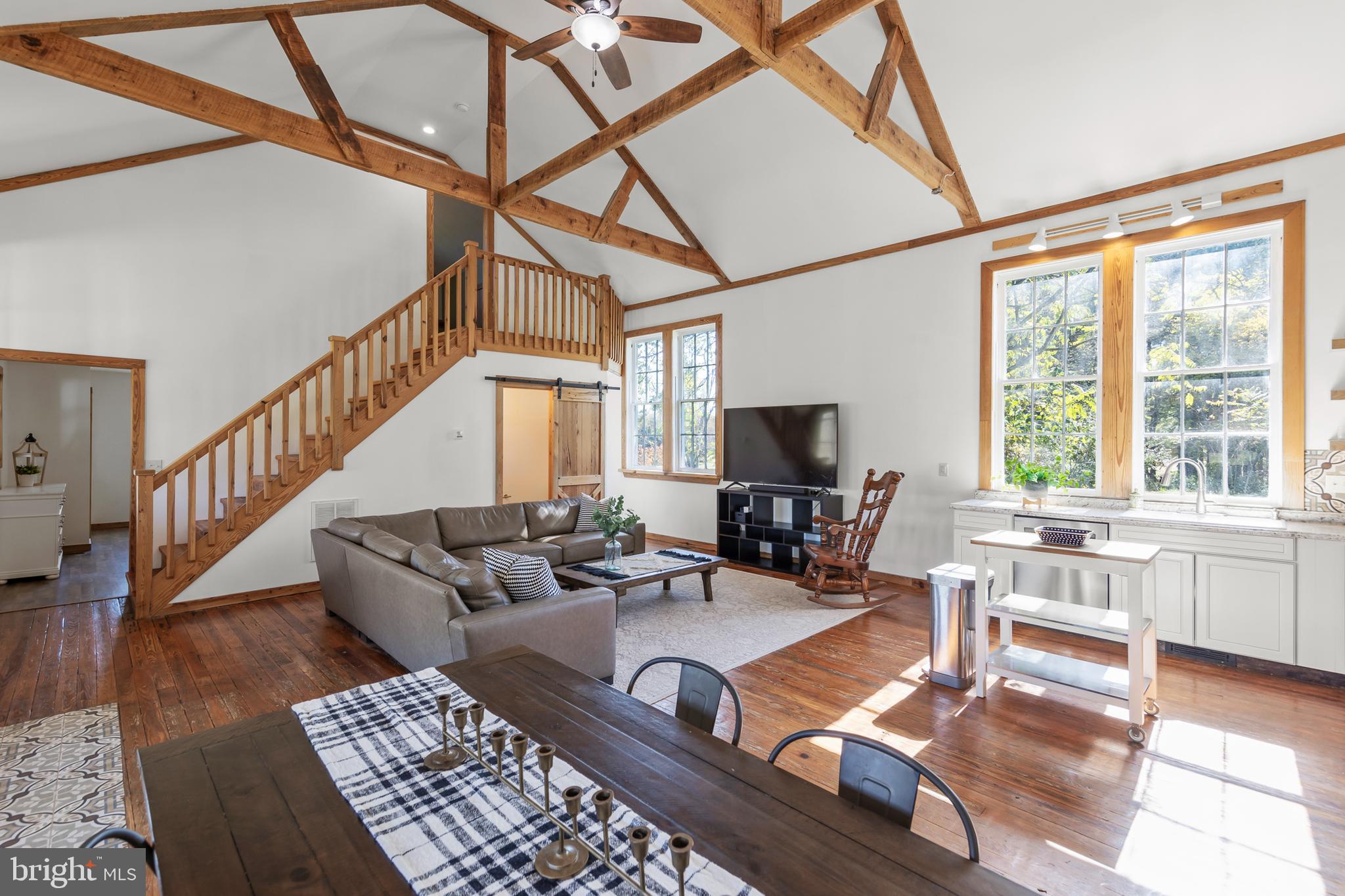 571 Rest Church Road Winchester, VA 22603 - Photo 6 of 45 a living room with furniture a flat screen tv and a large window