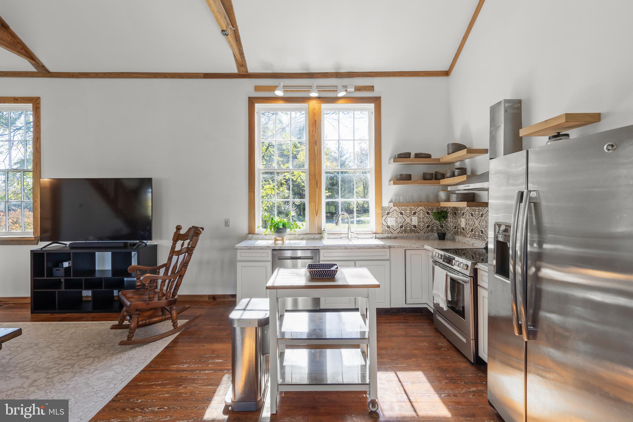 571 Rest Church Road Winchester, VA 22603 - Photo 7 of 45 a kitchen with a table chairs refrigerator and microwave