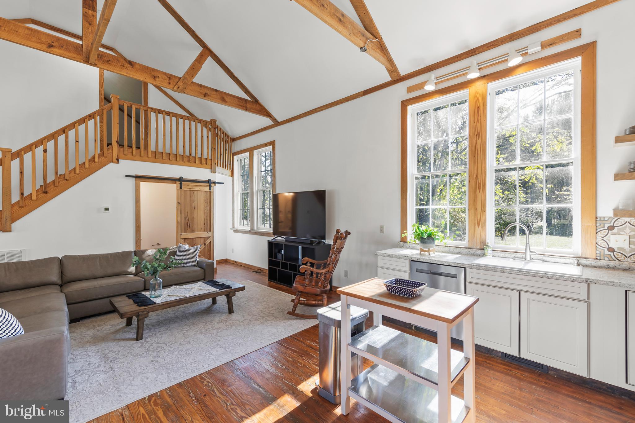 571 Rest Church Road Winchester, VA 22603 - Photo 8 of 45 a living room with furniture a flat screen tv and a large window
