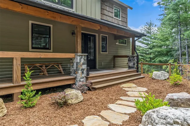 a kitchen with stainless steel appliances granite countertop a sink a stove a refrigerator cabinets and dining table