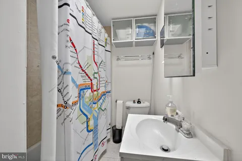 a bathroom with a sink and mirror with wooden floor