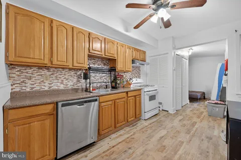 a kitchen with a sink cabinets and window