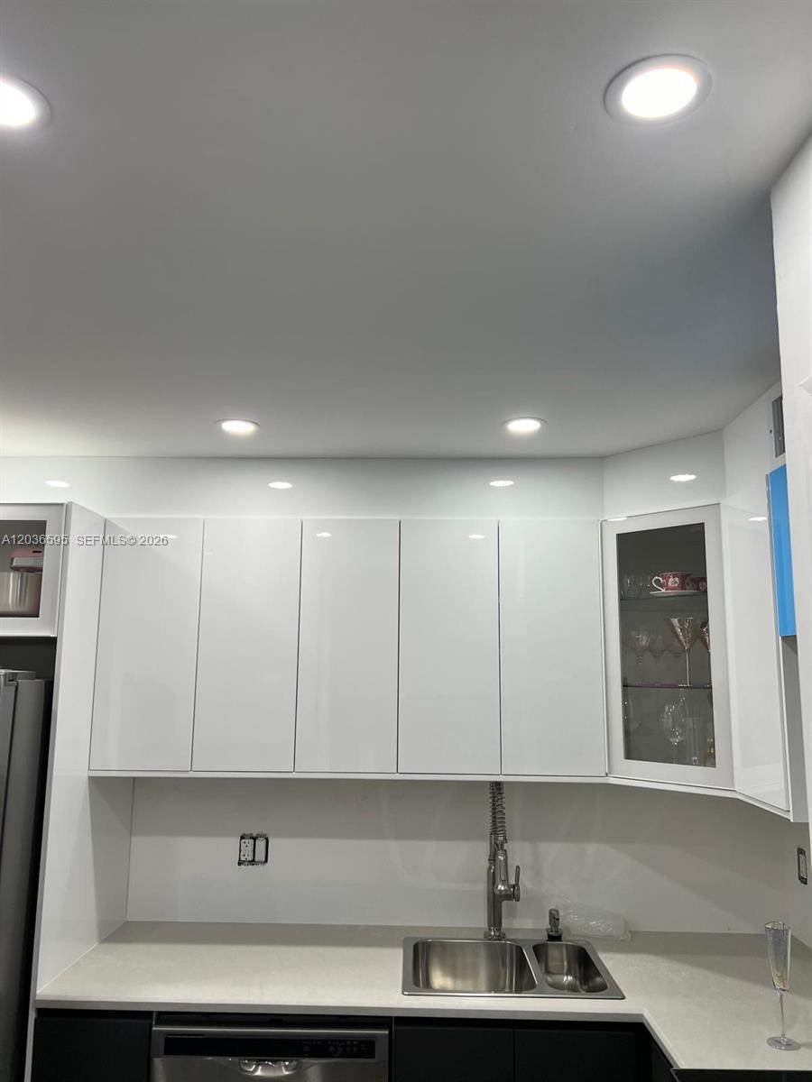 4164 Inverrary Drive, Unit 1004 Lauderhill, FL 33319 - Photo 6 of 15 a kitchen with stainless steel appliances granite countertop a sink and cabinets