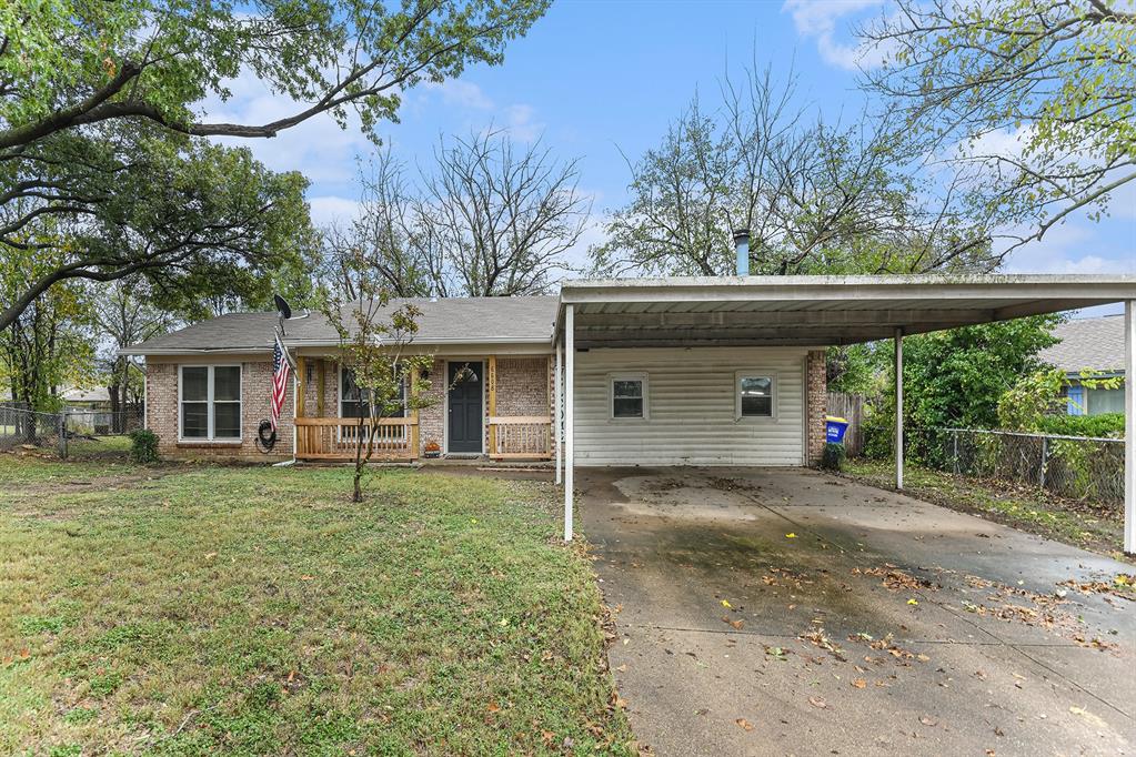 6608 Swanee Court Watauga, TX 76148 - Photo 1 of 30 a front view of a house with a garden