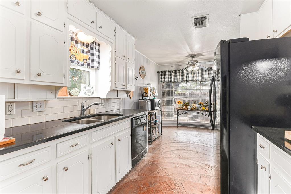 6608 Swanee Court Watauga, TX 76148 - Photo 13 of 30 a kitchen with stainless steel appliances granite countertop a refrigerator and a sink