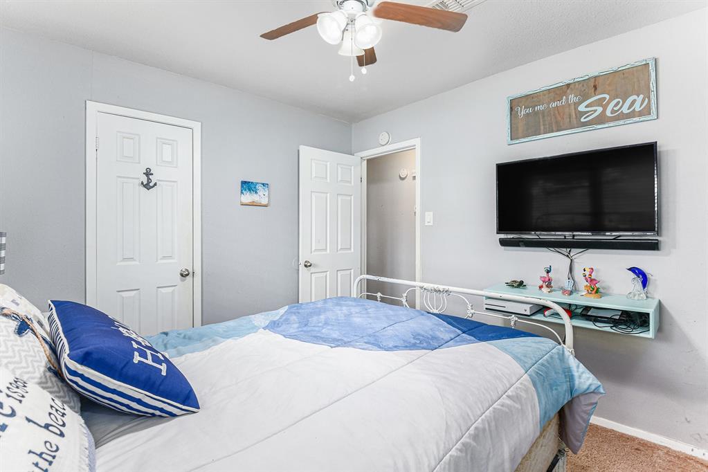 6608 Swanee Court Watauga, TX 76148 - Photo 23 of 30 a bedroom with a bed and a flat screen tv