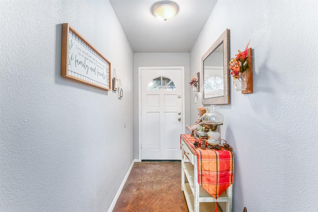 6608 Swanee Court Watauga, TX 76148 - Photo 3 of 30 a hallway with painting on the wall and wall painting