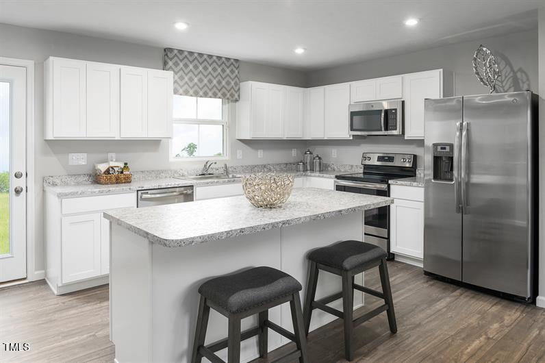 3821 Dragonfly Road Bailey, NC 27807 - Photo 2 of 10 a kitchen with stainless steel appliances granite countertop a white cabinets and a refrigerator