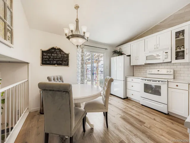 a bathroom with a toilet a sink a mirror and vanity