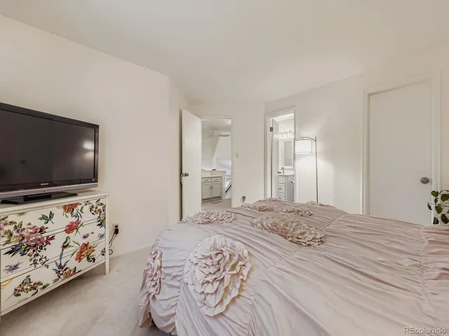 a view of a patio with table and chairs potted plants with wooden floor and fence