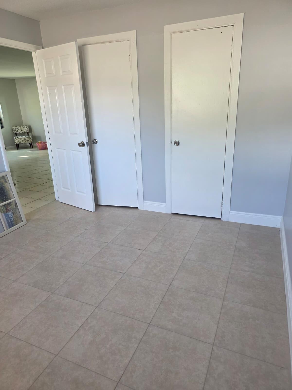 3386 Rudolph Road Lake Worth Beach, FL 33461 - Photo 18 of 25 an empty room with a mirror