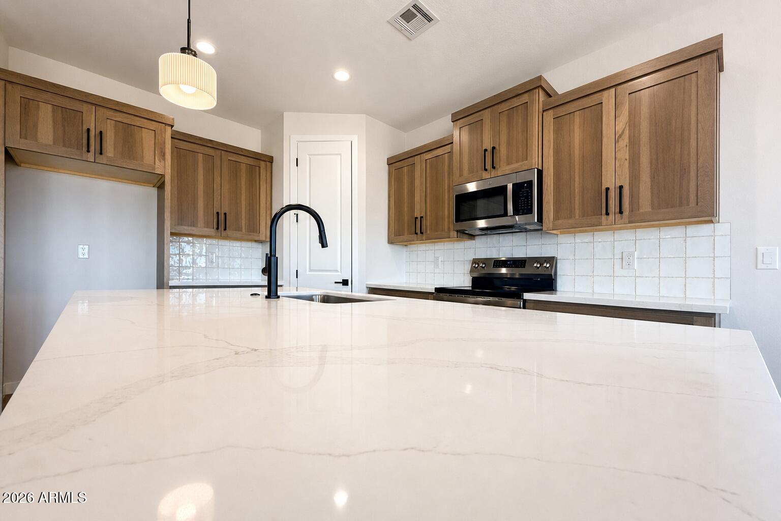 16957 East Bobwhite Way Rio Verde, AZ 85263 - Photo 7 of 25 a kitchen with a sink and a stove top oven