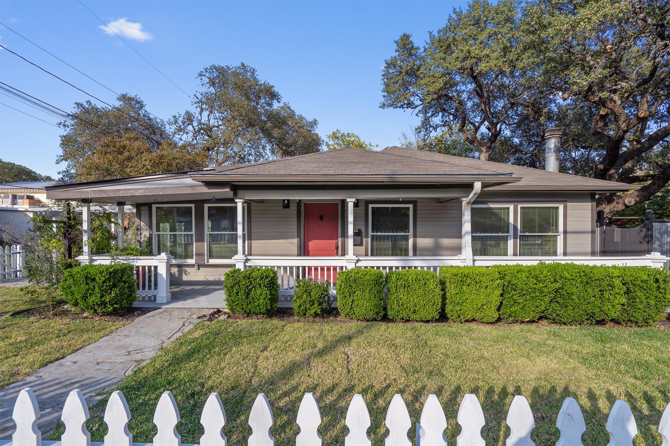 a front view of a house with garden and porch