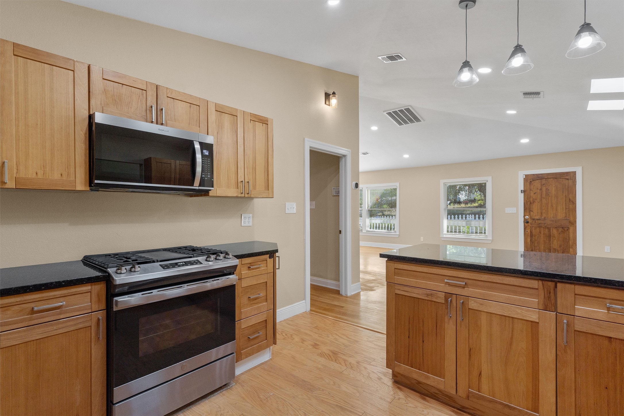 400 East Monroe Street Austin, TX 78704 - Photo 13 of 39 a kitchen with stainless steel appliances granite countertop a stove a microwave and a sink
