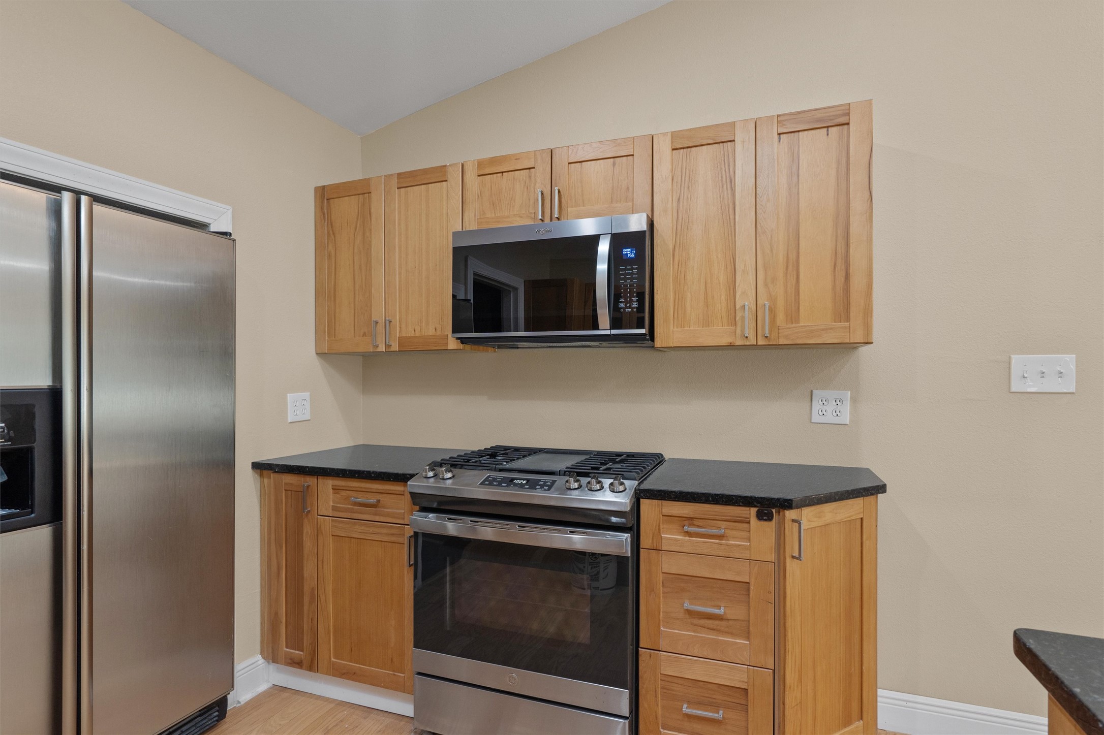 400 East Monroe Street Austin, TX 78704 - Photo 14 of 39 a kitchen with stainless steel appliances granite countertop a stove microwave and refrigerator