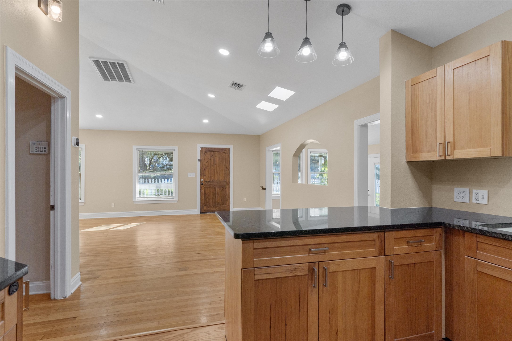 400 East Monroe Street Austin, TX 78704 - Photo 16 of 39 a kitchen with granite countertop cabinets and wooden floor