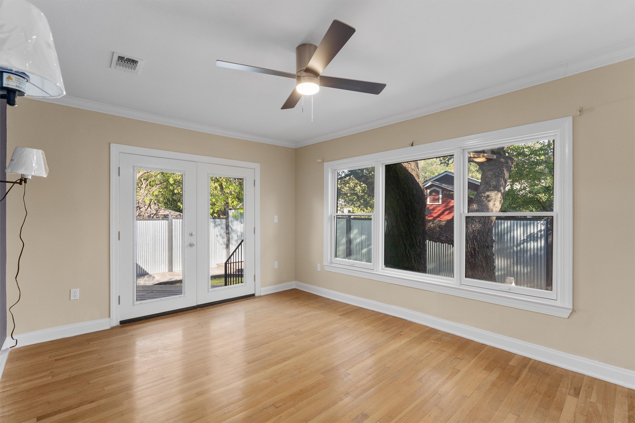 400 East Monroe Street Austin, TX 78704 - Photo 17 of 39 a view of an empty room with a window and wooden floor