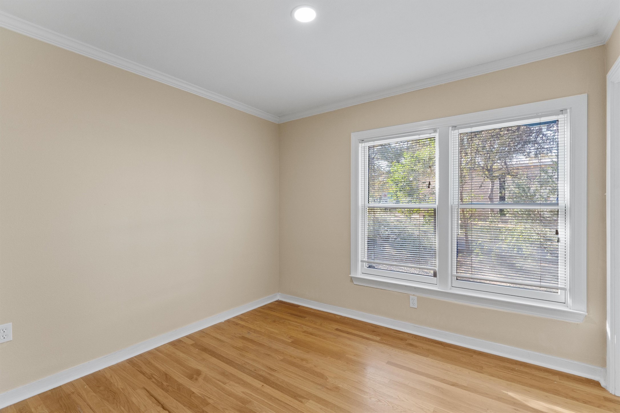 400 East Monroe Street Austin, TX 78704 - Photo 24 of 39 a view of an empty room with wooden floor and a window