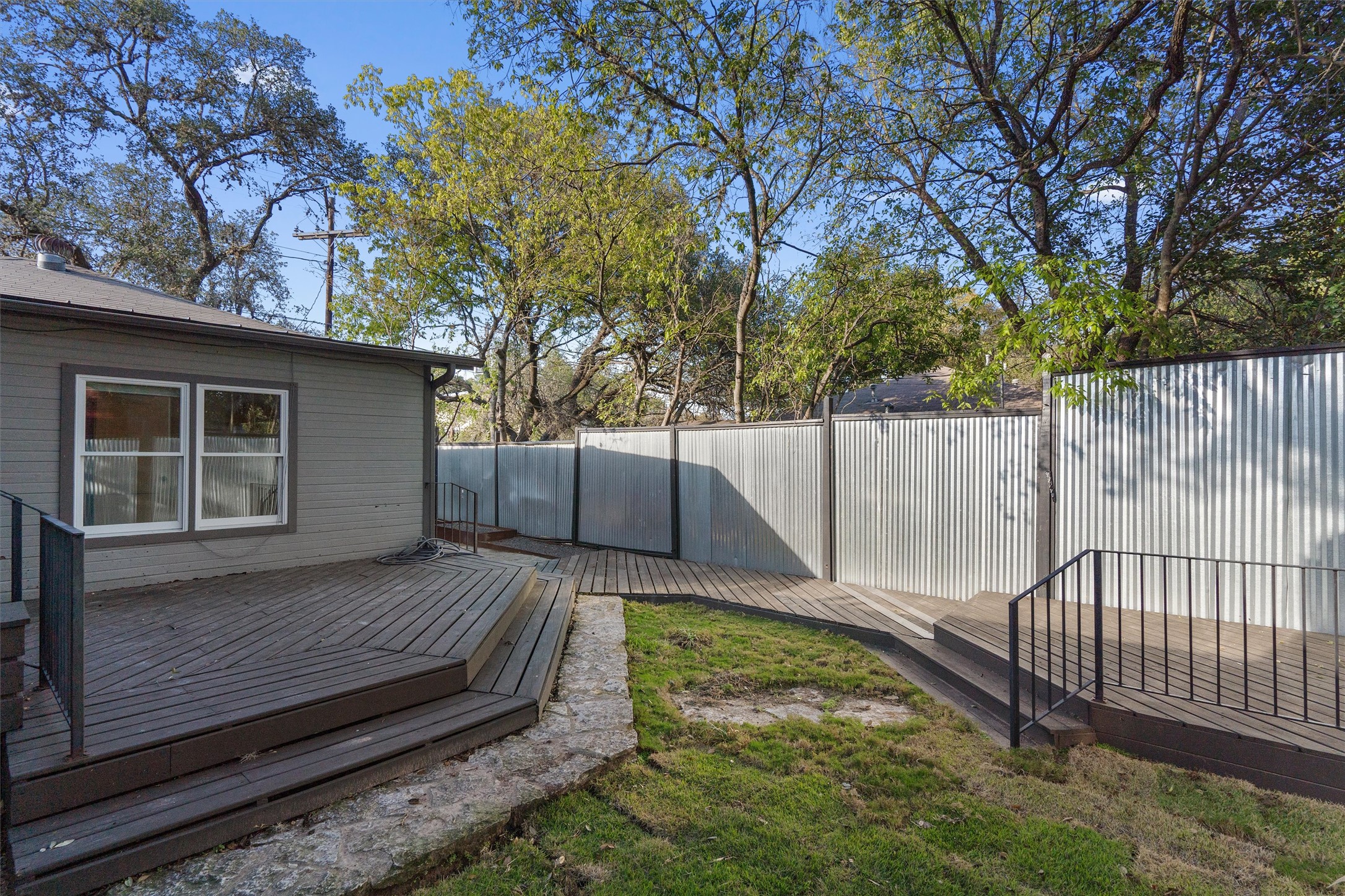 400 East Monroe Street Austin, TX 78704 - Photo 36 of 39 a view of backyard with wooden fence and a large tree