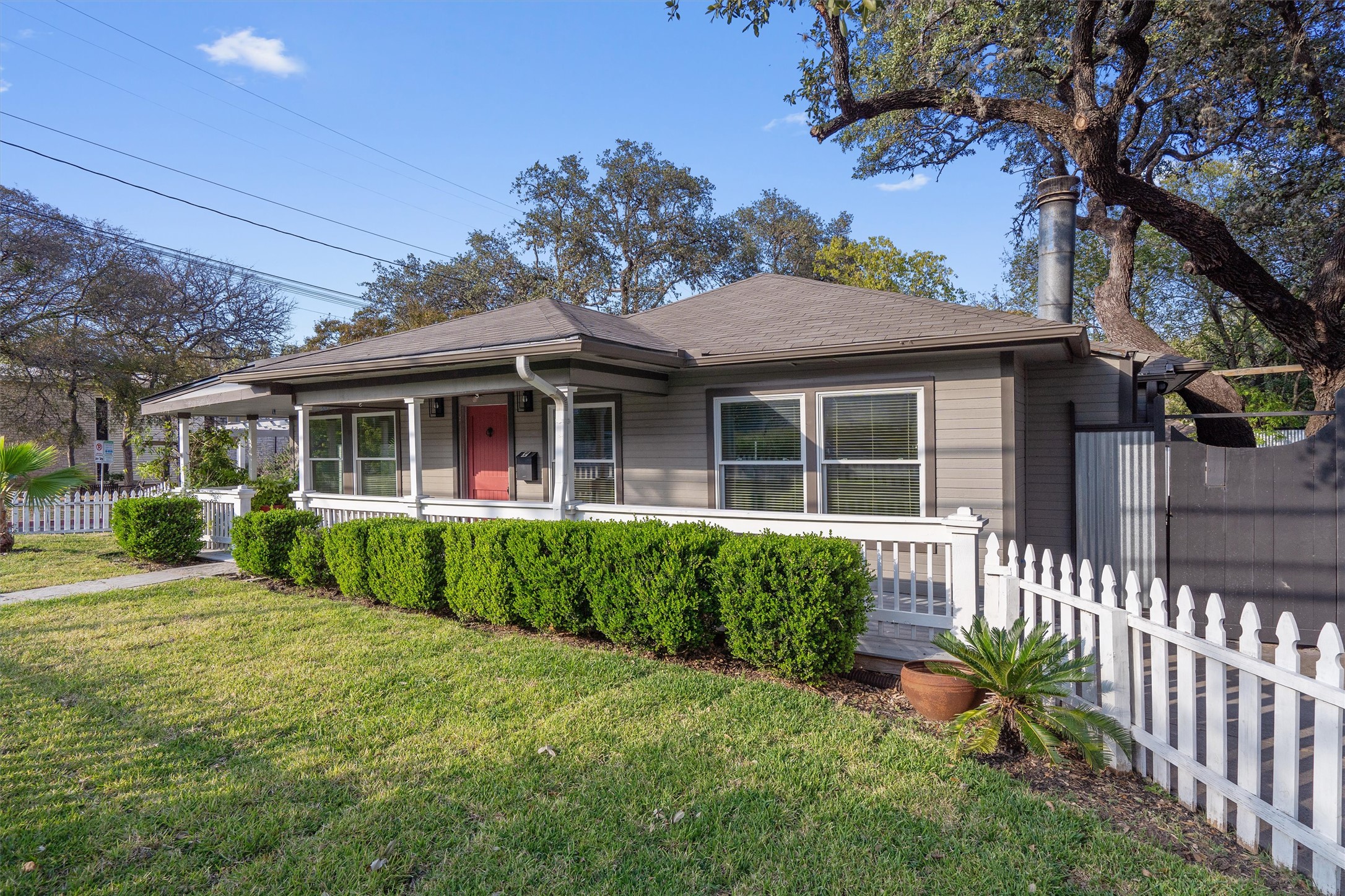 400 East Monroe Street Austin, TX 78704 - Photo 4 of 39 a front view of a house with a garden
