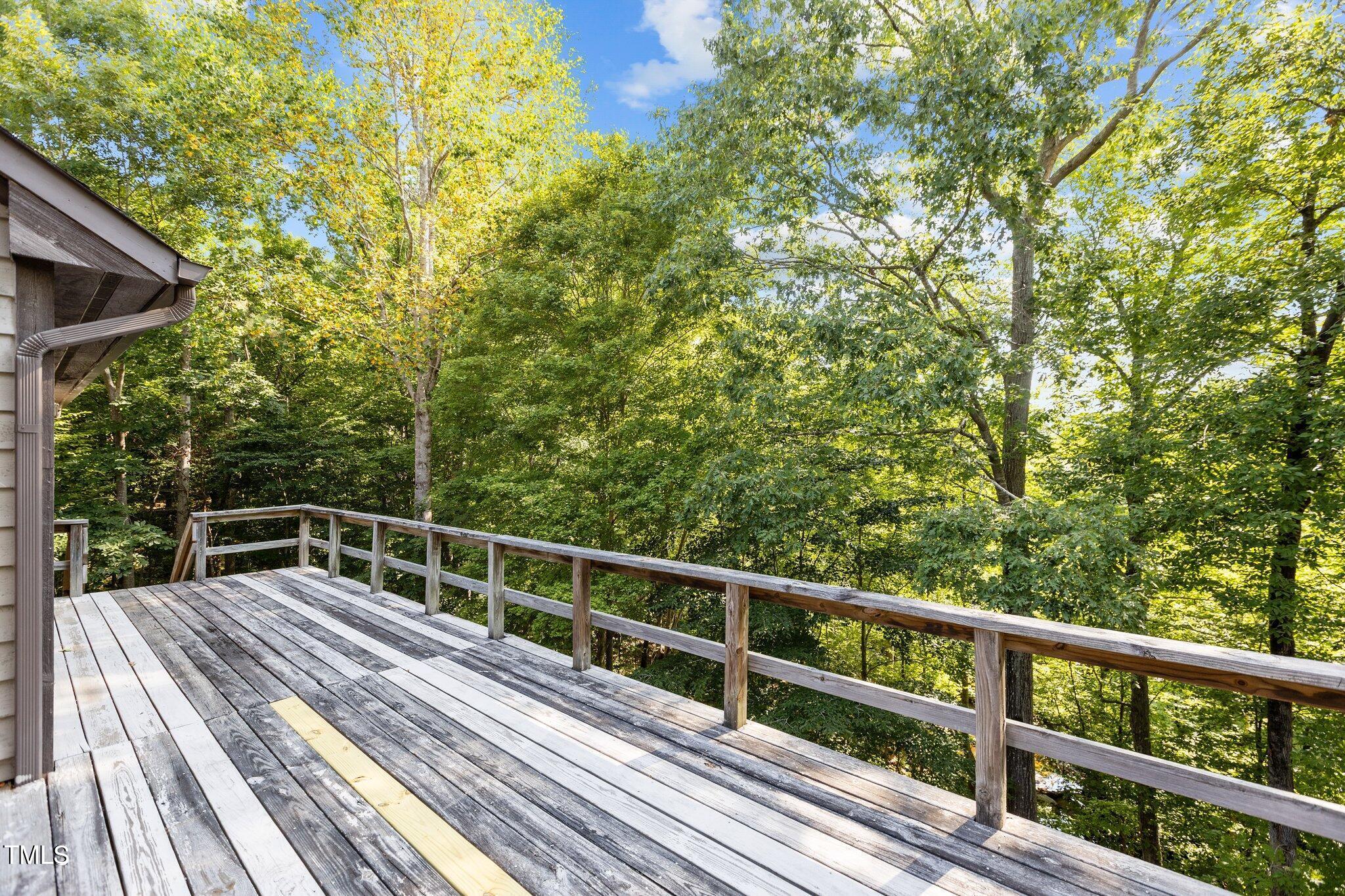 5900 Ebenezer Church Road Raleigh, NC 27612 - Photo 13 of 71 a view of balcony with deck and trees