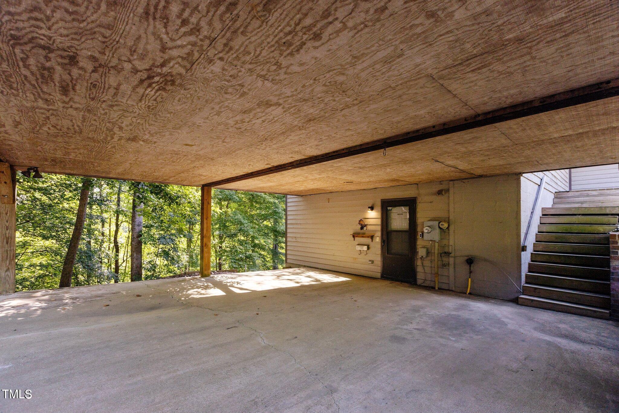 5900 Ebenezer Church Road Raleigh, NC 27612 - Photo 17 of 71 a view of an empty room with a fireplace and large windows