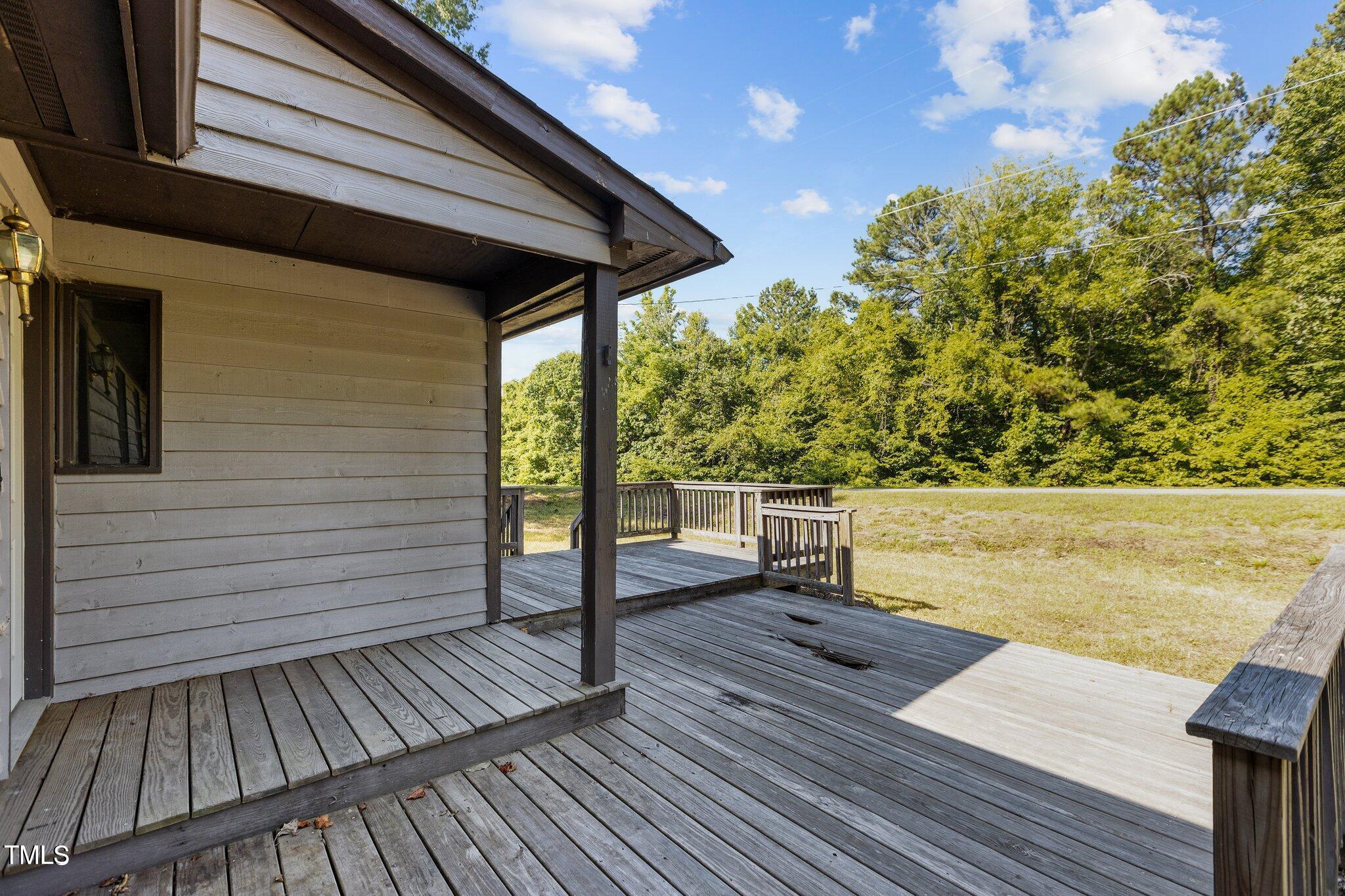 5900 Ebenezer Church Road Raleigh, NC 27612 - Photo 19 of 71 a view of deck with chairs and wooden floor