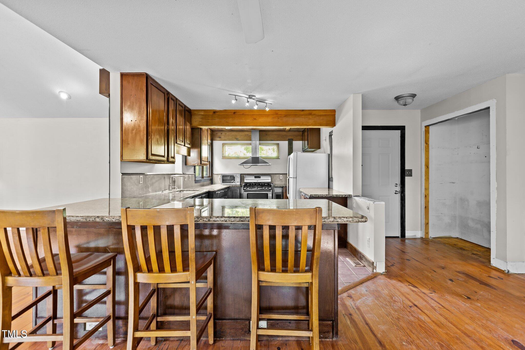 5900 Ebenezer Church Road Raleigh, NC 27612 - Photo 31 of 71 a view of a dining room with furniture window and wooden floor