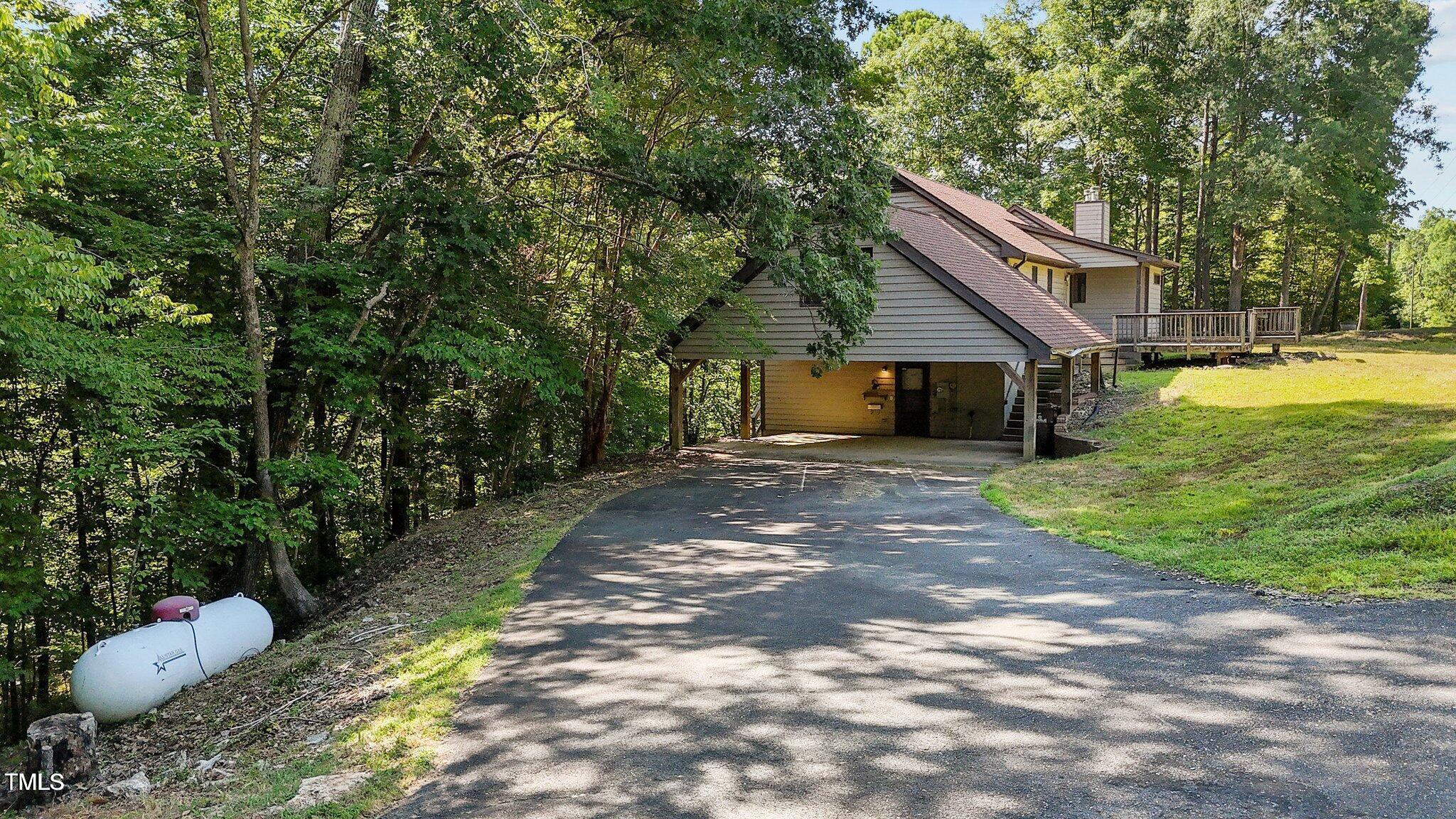 5900 Ebenezer Church Road Raleigh, NC 27612 - Photo 47 of 71 a front view of a house with a yard and trees