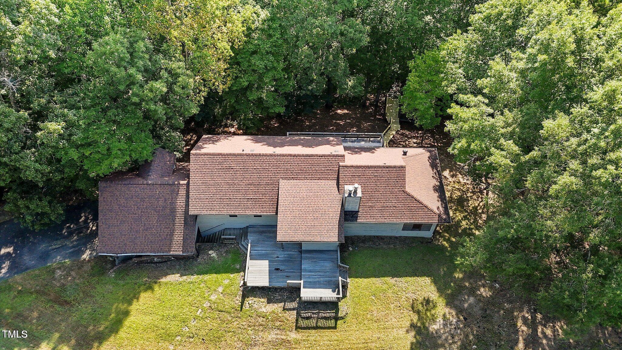 5900 Ebenezer Church Road Raleigh, NC 27612 - Photo 52 of 71 an aerial view of a house with swimming pool and large trees