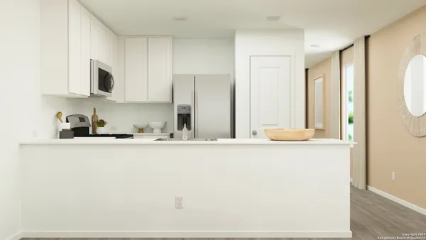 a kitchen with stainless steel appliances granite countertop a sink a stove and a refrigerator