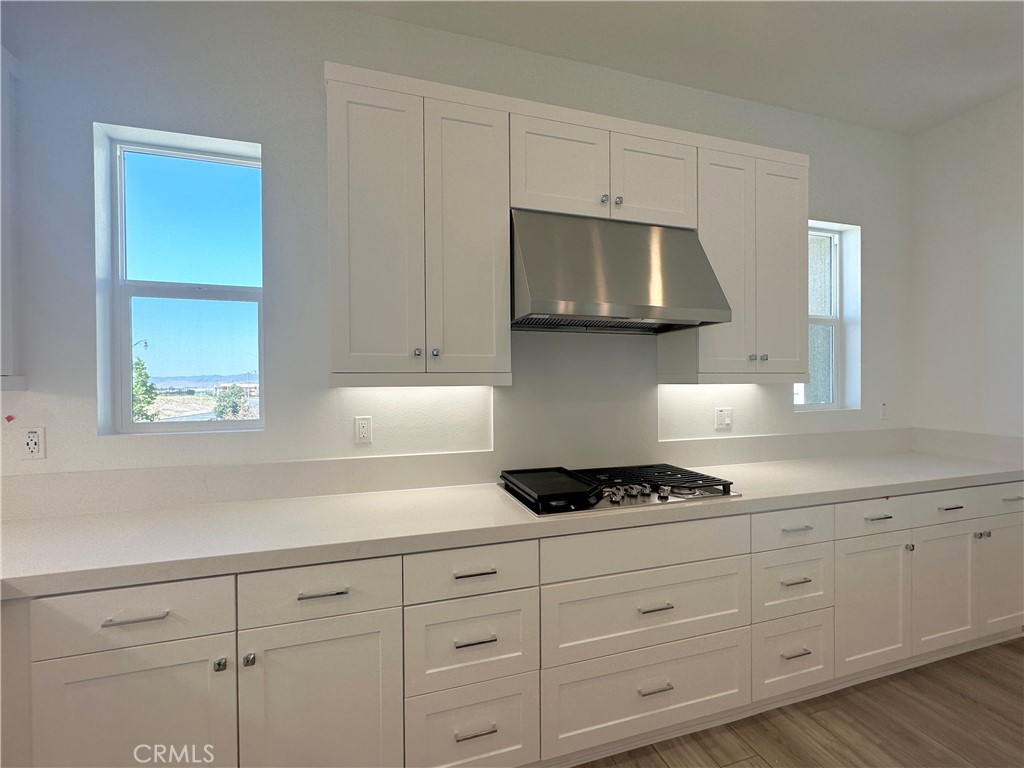 322 Tank Irvine, CA 92618 - Photo 11 of 43 a kitchen with white cabinets a stove and a window
