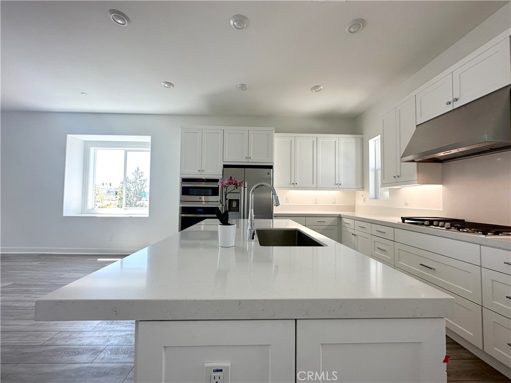 322 Tank Irvine, CA 92618 - Photo 12 of 43 a kitchen with a stove a sink and a refrigerator