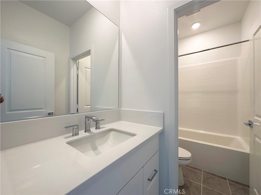 322 Tank Irvine, CA 92618 - Photo 35 of 43 a bathroom with a granite countertop sink mirror toilet and bathtub