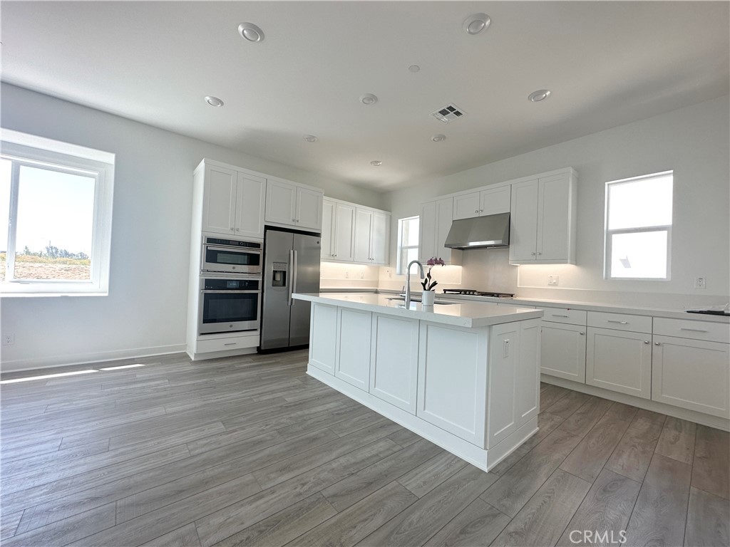322 Tank Irvine, CA 92618 - Photo 10 of 43 a kitchen with stainless steel appliances a stove top oven and a refrigerator