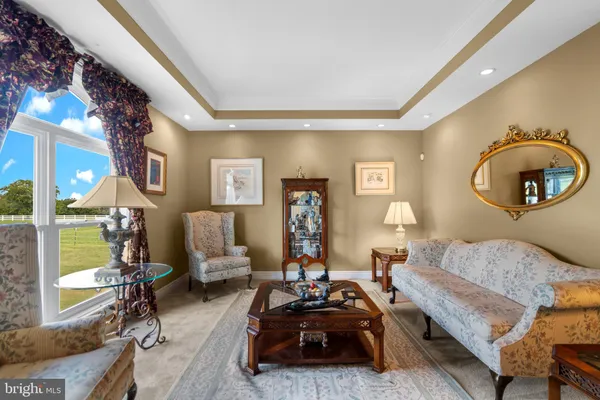 a living room with furniture and a mirror