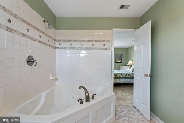 a bathroom with a tub and shower