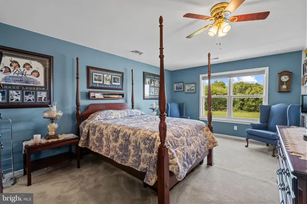 a bedroom with a bed dresser and a window