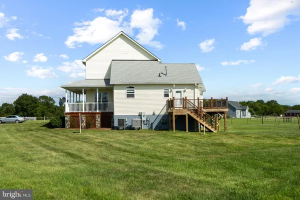 a view of a house with a big yard and a large tree