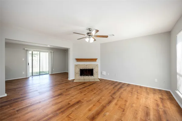 wooden floor in an empty room with a fireplace