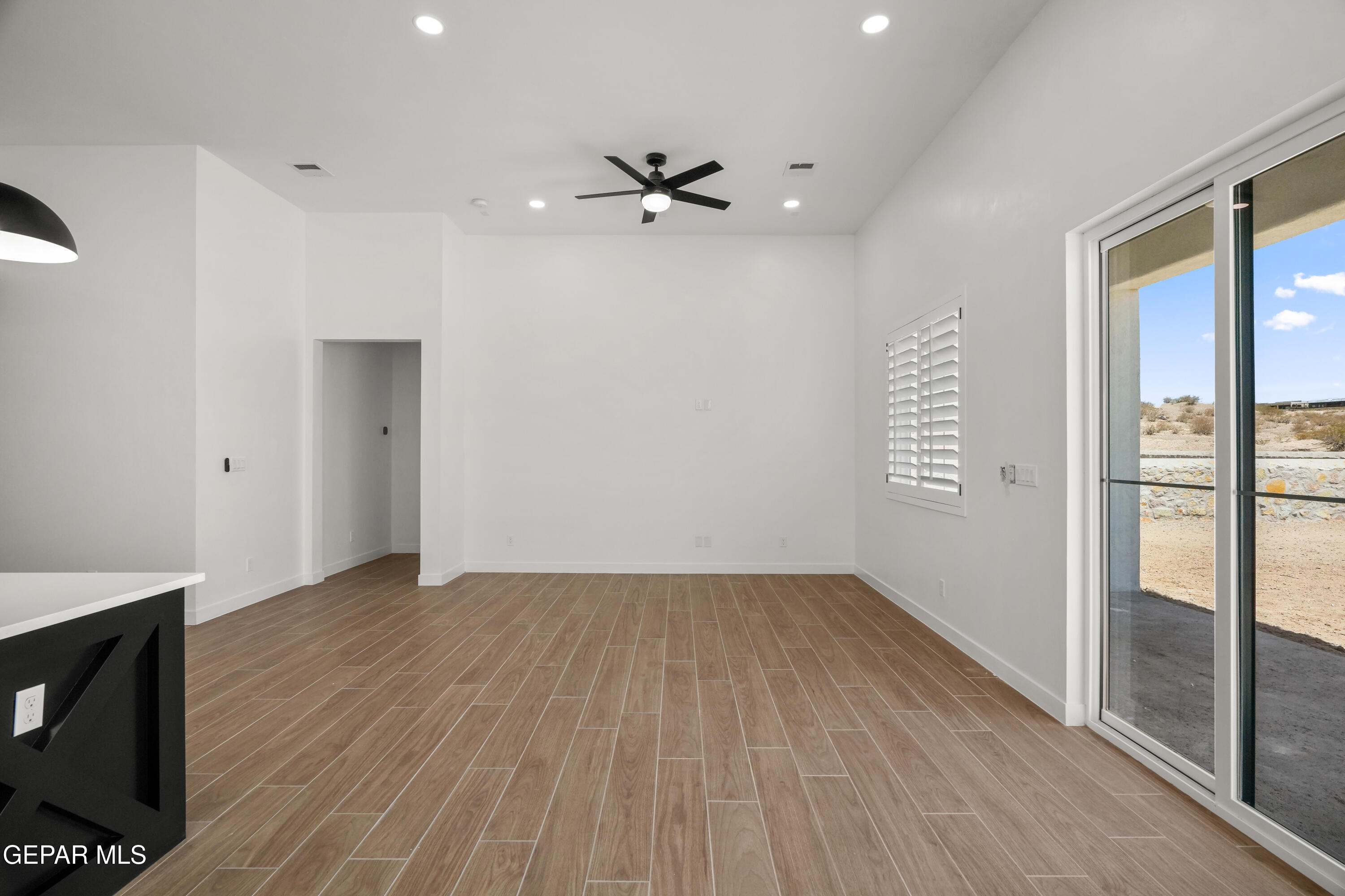 15225 Expectation El Paso, TX 79938 - Photo 21 of 38 a view of an empty room with wooden floor and a window