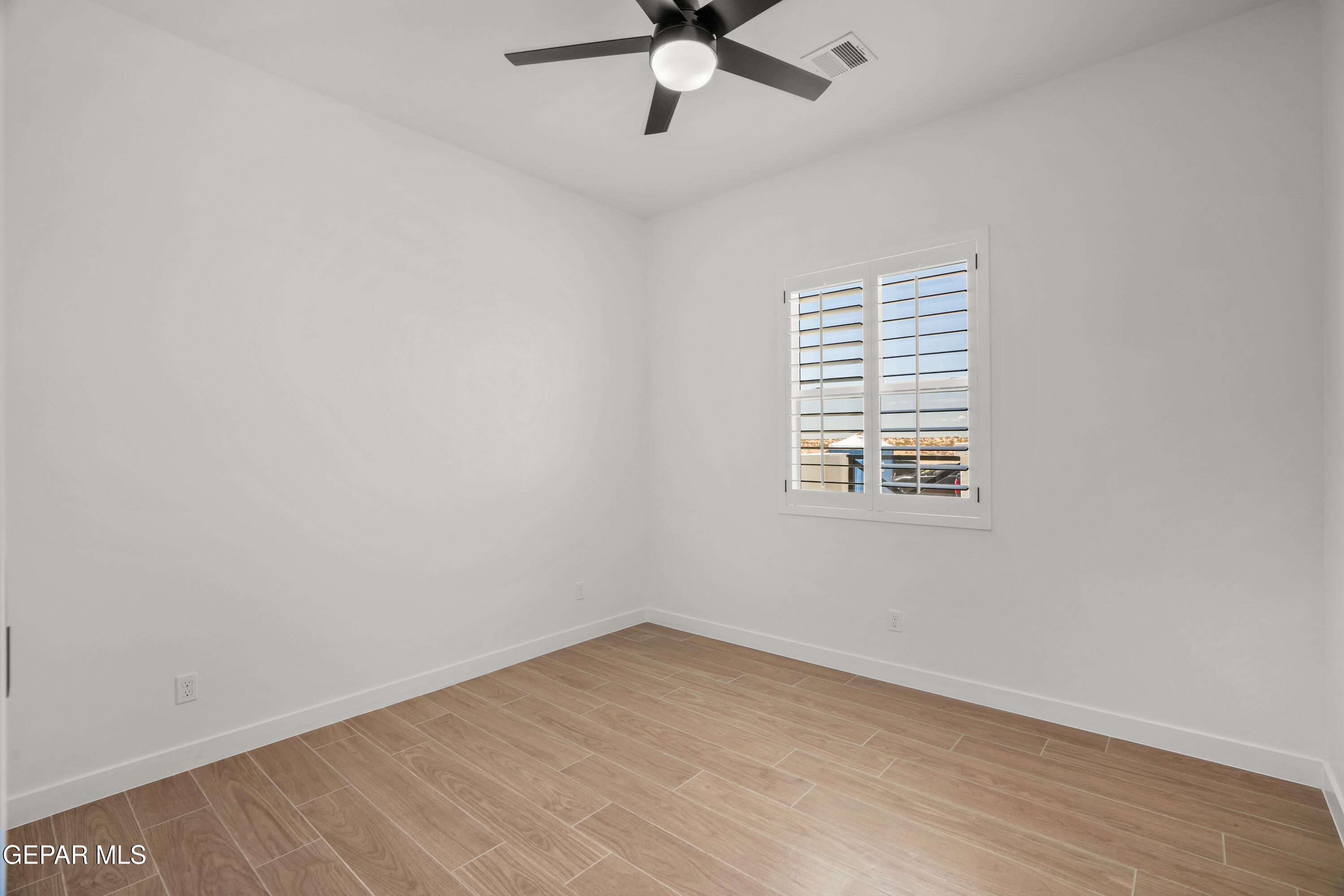 15225 Expectation El Paso, TX 79938 - Photo 7 of 38 an empty room with a window and a fan