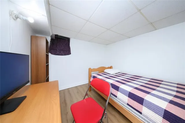 a bedroom with a bed and a lamp