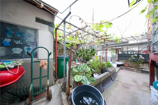 a front view of a house with garden and sitting area
