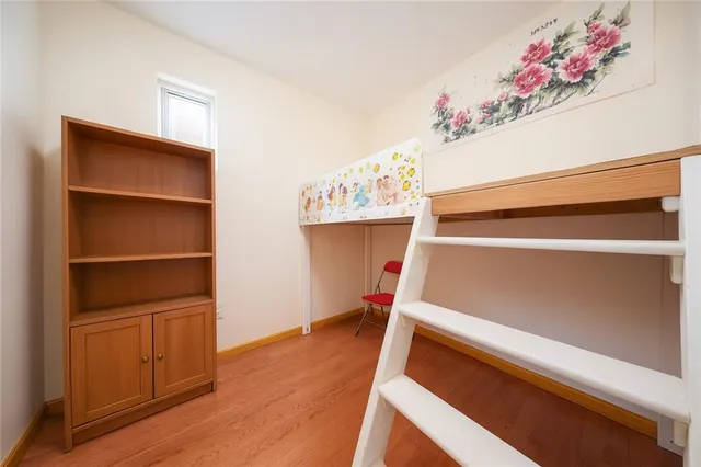 a view of an empty room with cabinet and a window