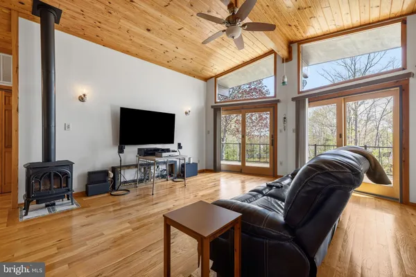 a view of an empty room and wooden floor and door